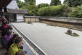 Visitors watching Ryoan-ji dry garden Kyoto Japan